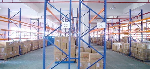 High-bay warehouse racking holding finished goods and components